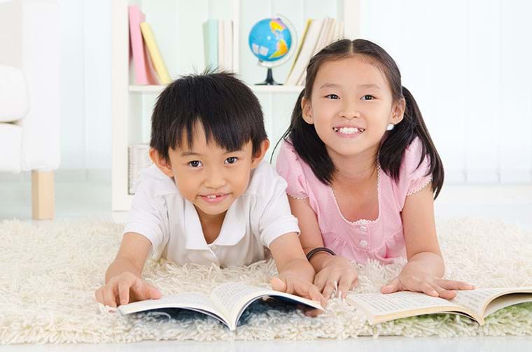 Two children read together