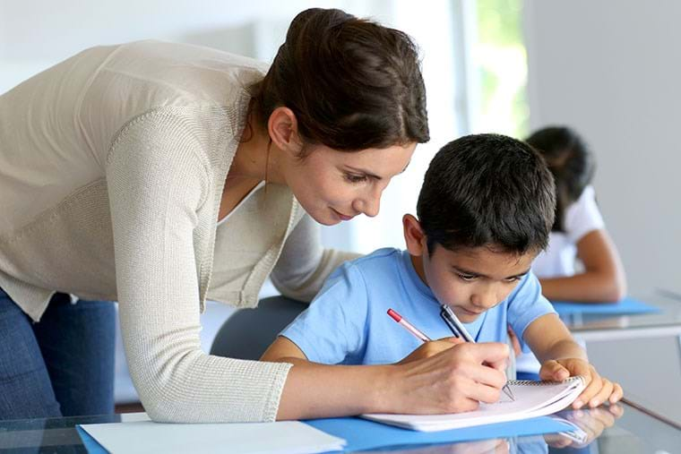 A teacher helps her student