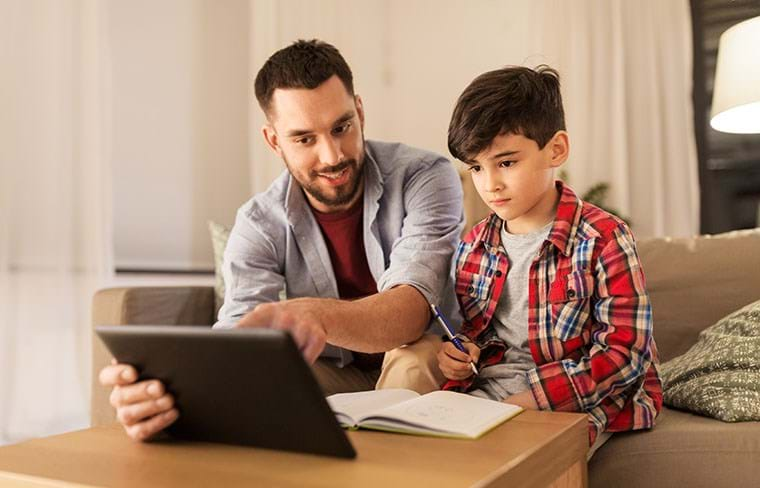 A parent helps his child with homework