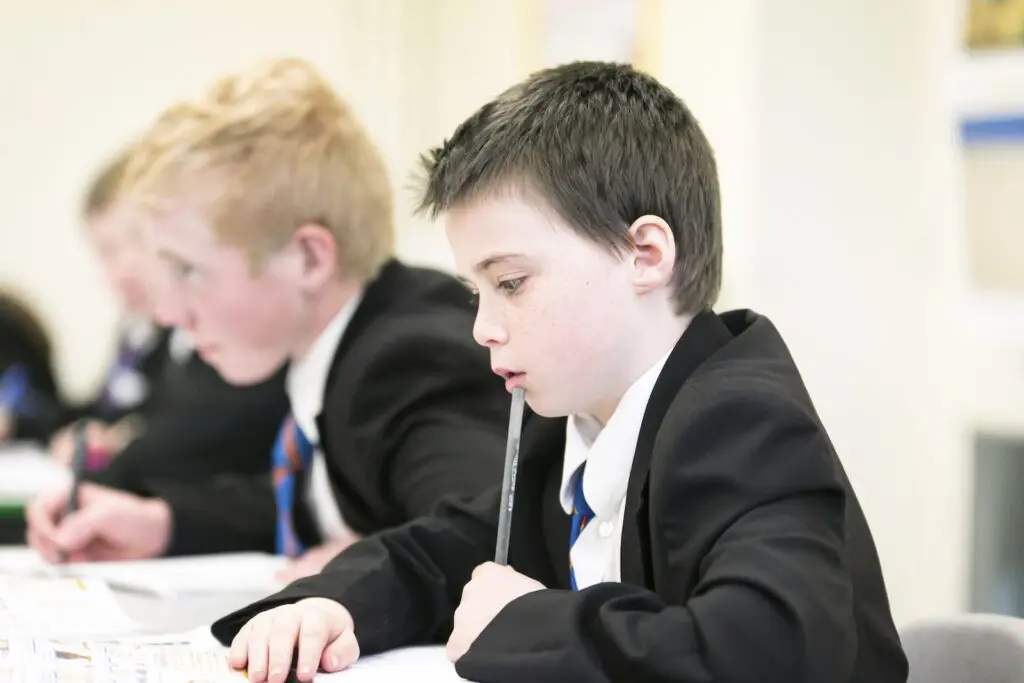 Students in school uniforms working.