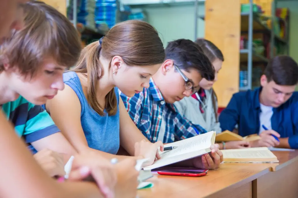 A group of secondary school students studying in a library.