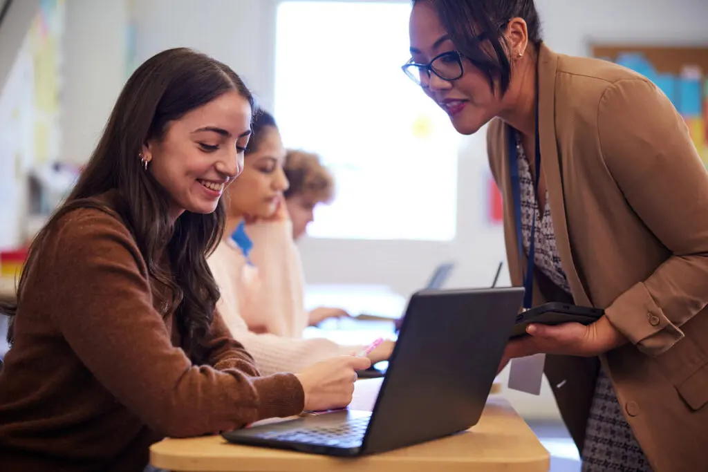 Teachers working at a laptop